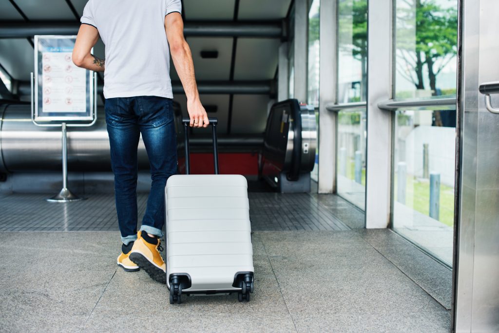 airport transfer passenger wheeling luggage